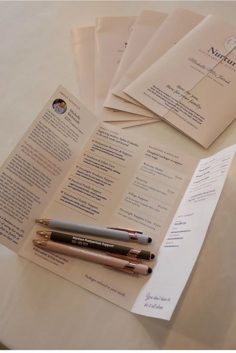 Nurture welcome booklets and pens laid out on a table