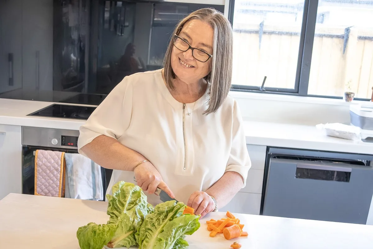 Michelle chopping vegetables for a family meal in a bright kitchen